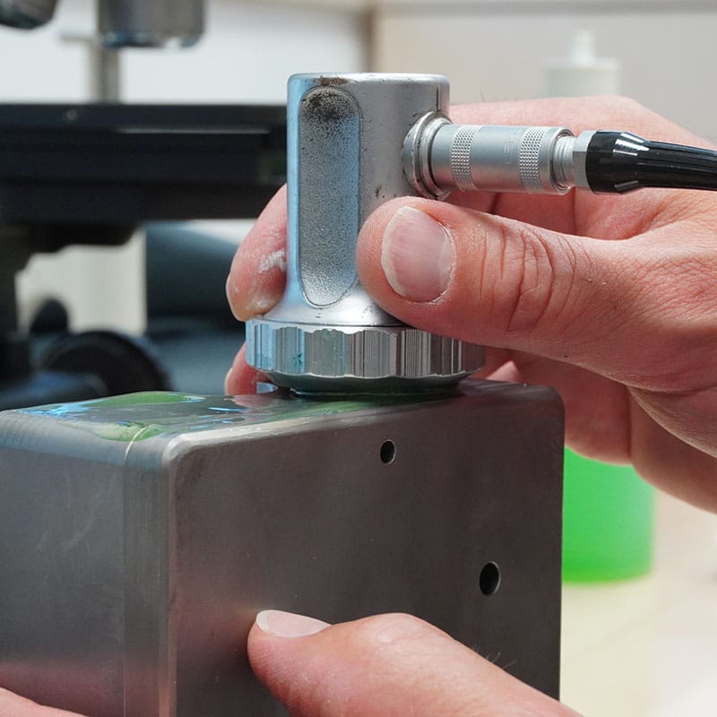 Ultrasonic testing steel with UT probe to detect internal defects, cracks, porosity and inclusions without damaging the material.